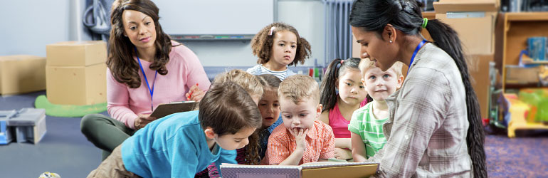 Preschool teacher reading to children