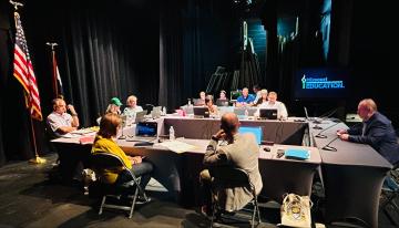 State board members voting at meeting